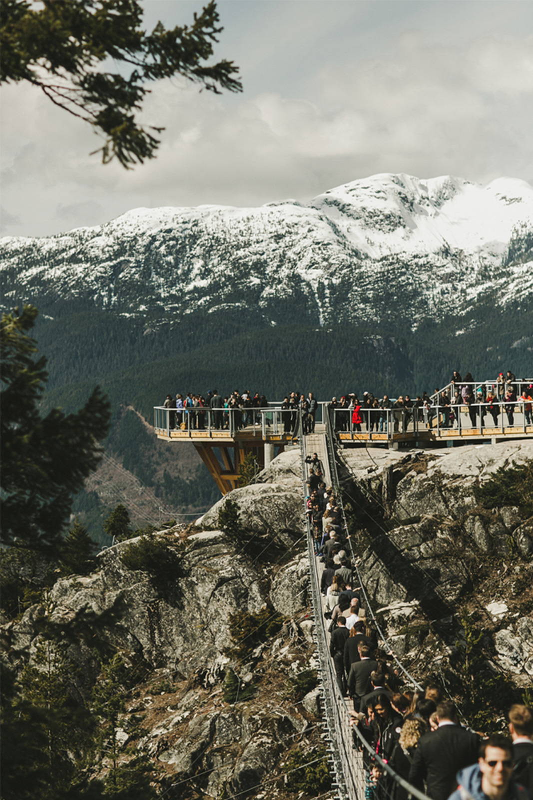 Guests lined up on bridge in Canadian mountains