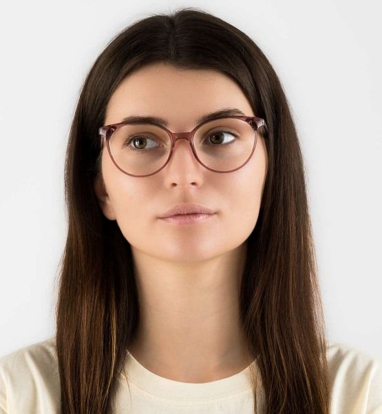 woman wearing Felicity Pink oval low bridge glasses on a white background