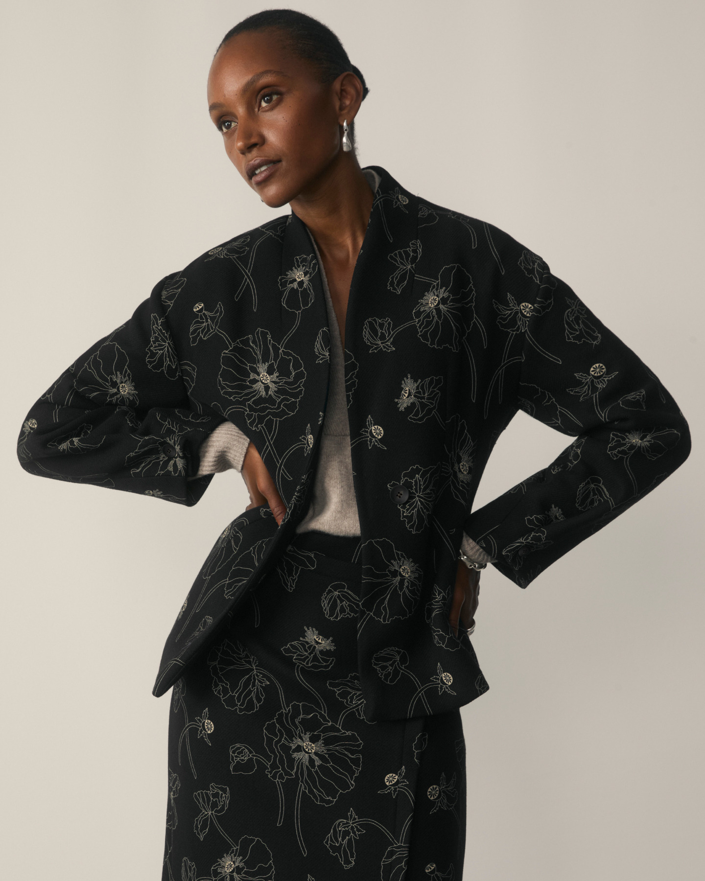 Model wearing Camelia Wool Skirt and Everleigh Wool Jacket Black And Ivory Manteco x Liberty Fabrics