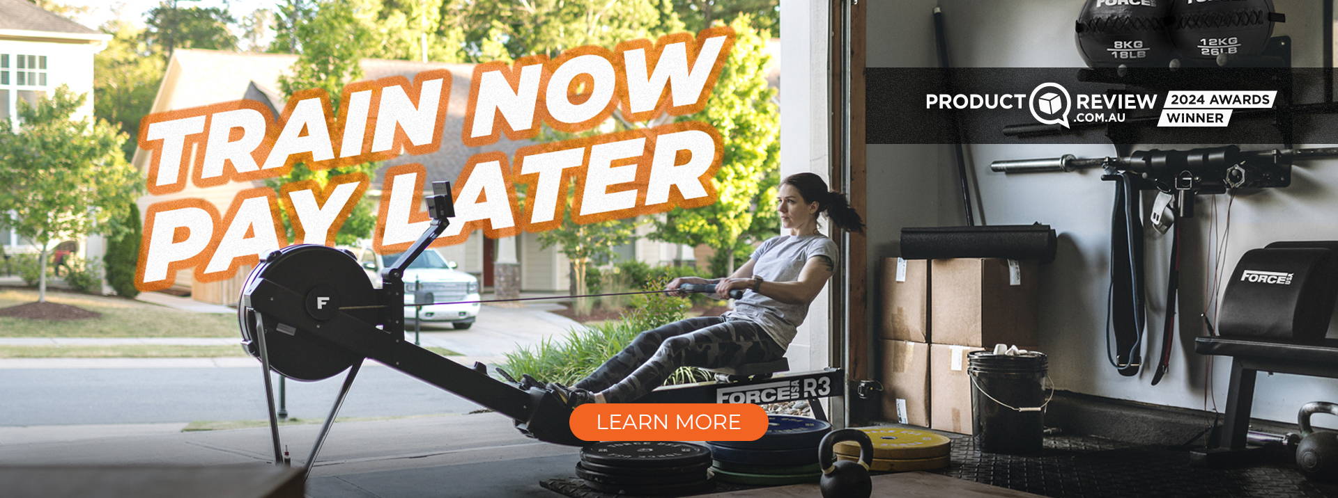 A woman is working out using a Force USA rowing machine in a home garage turned into a gym, with various gym equipment visible in the background. The large text overlay reads 'TRAIN NOW, PAY LATER' in a bold, orange font. On the right side of the image, there's a black badge stating 'PRODUCT REVIEW 2024 AWARDS WINNER' with the logo of productreview.com.au,