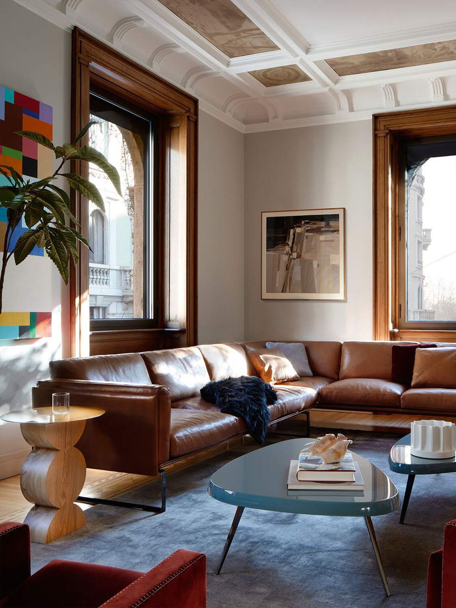 Modern living room with la Cassina 8 Leather sofa, coffee table, and large windows.