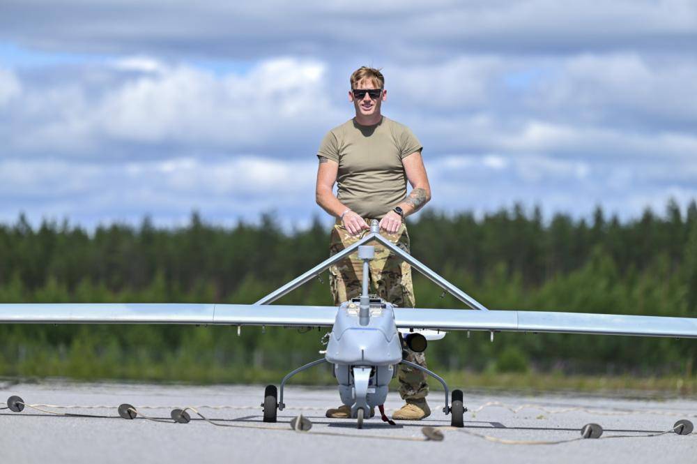 U.S. Army Sgt. Christoper Tweedy, a St. Maries, ID native and unmanned aerial system technical inspector, assigned to 588th Brigade Engineer Battalion, 3rd Armored Brigade Combat Team, 4th Infantry Division detaches a U.S. Army AAI RQ-7 Shadow UAS from the arresting gear following a successful landing at Niinisalo, Finland, July 8, 2022. The 3rd Armored Brigade Combat Team, 4th Infantry Division is among other units assigned to the 1st Infantry Division, proudly working alongside NATO allies and regional security partners to provide combat-credible forces to V Corps, America's forward deployed corps in Europe. (U.S. Army photo by Capt. Tobias Cukale)