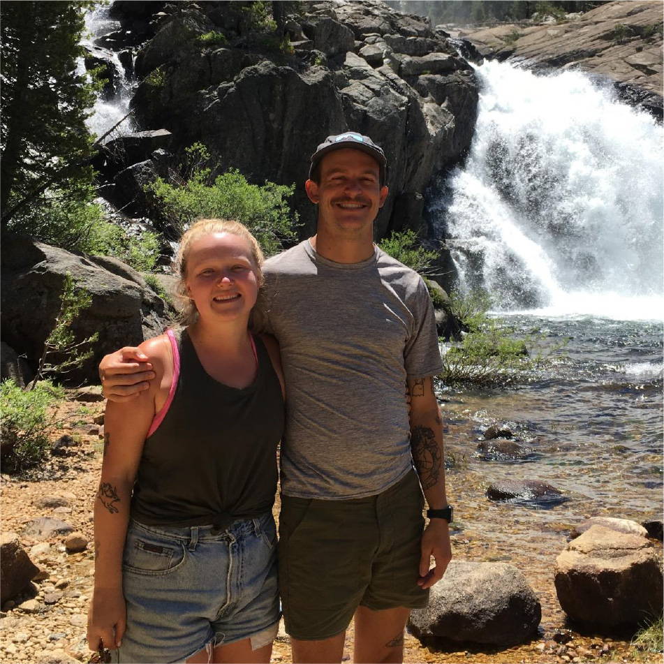 Brent Shenton and his partner by a waterfall
