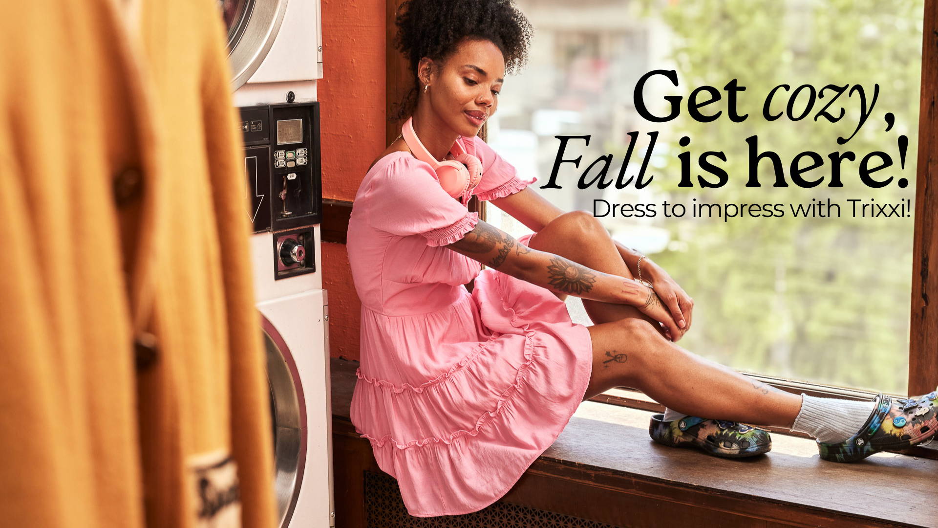 Get Cozy, Fall is here, dress to impress with Trixxi- girl in laundromat in barbie pink tier ruffle mini dress.