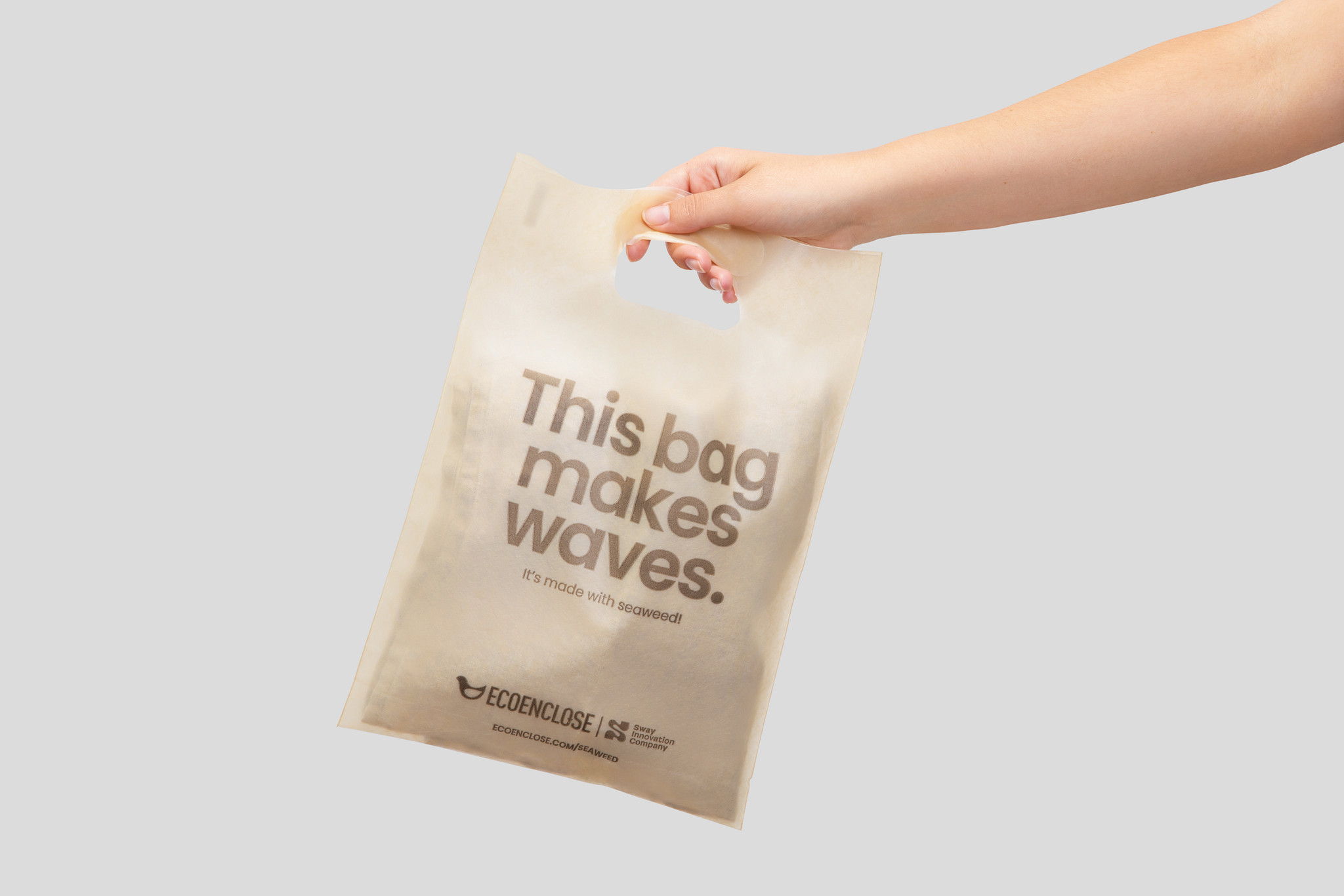 A hand holding a bag with 