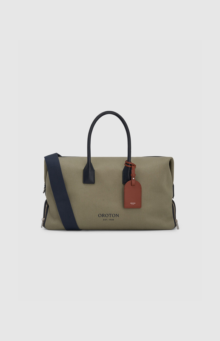 Olive green duffle bag with black handles and a brown tag.