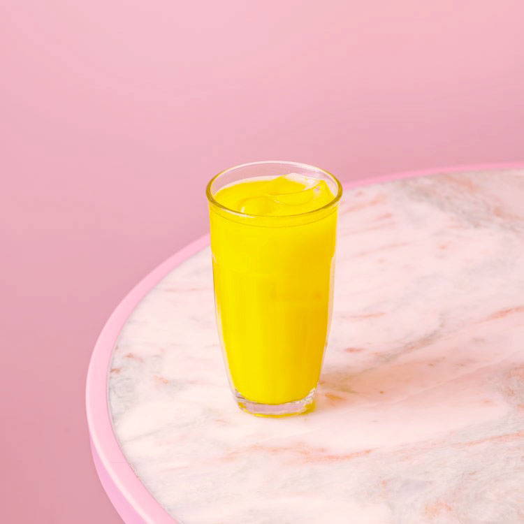 Orange Juice in front of pink wall