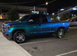 Side profile Brian's 2015 Toyota Tundra iridescent color-shifting wrap teal to royal blue chrome five-spoke wheels night parking lot Conductor's Special 228H featured customer install gallery photo 1