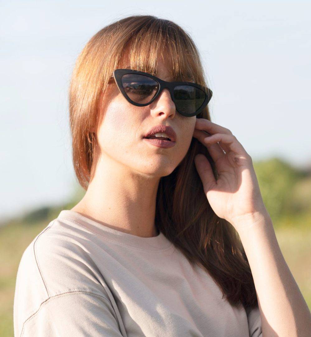Woman with big nose wearing Selena, Small Cat-Eye Wooden Sunglasses