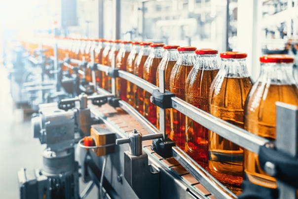 Glass bottles on conveyor belt in a factory