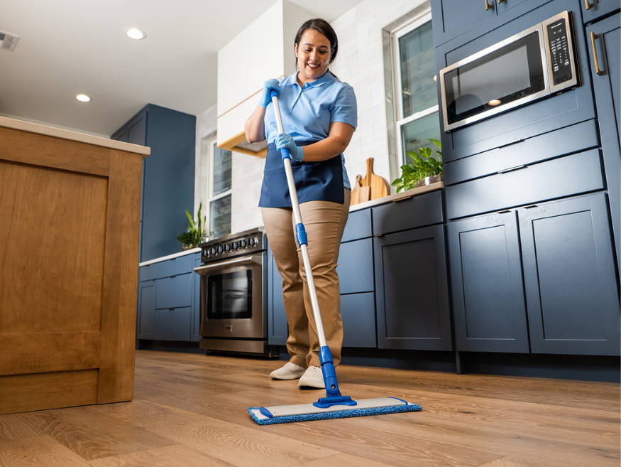 woman cleaning floor with microfiber mop