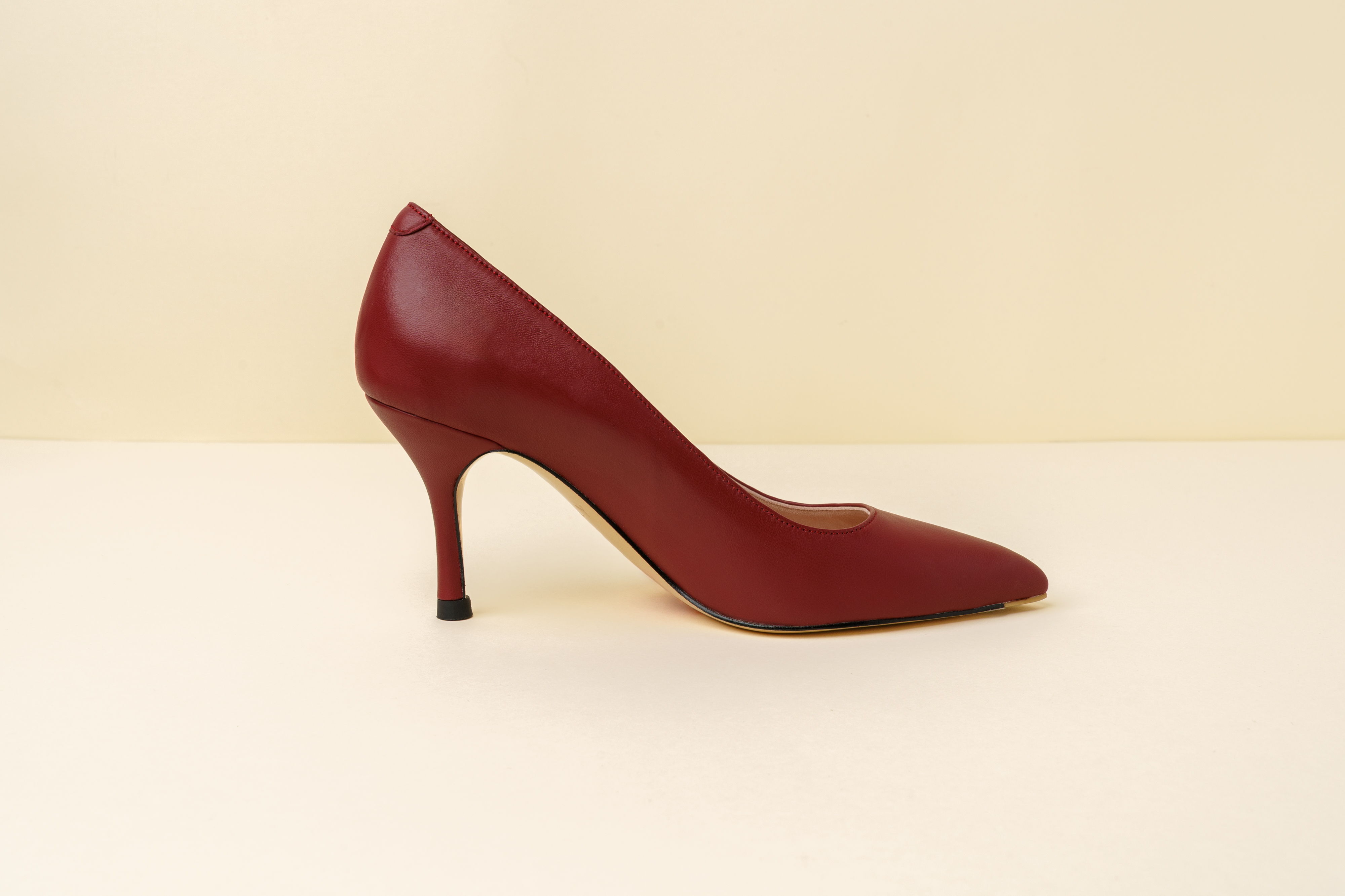 Red high-heeled shoe against a plain background.