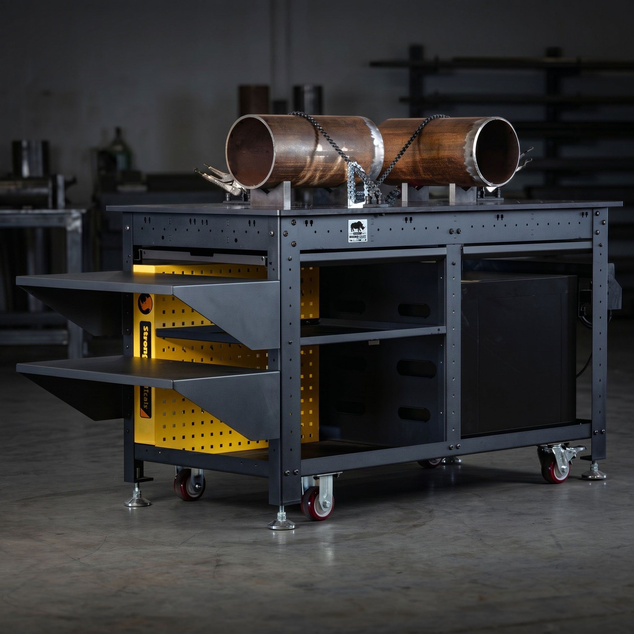 A sturdy workbench with metal pipes and storage drawers, set in a workshop.