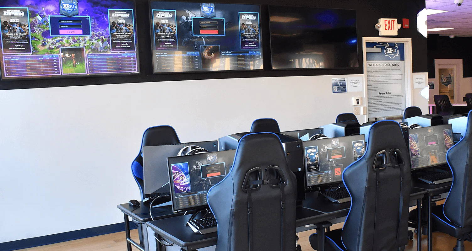 A gaming setup with multiple computers and screens in a modern room.