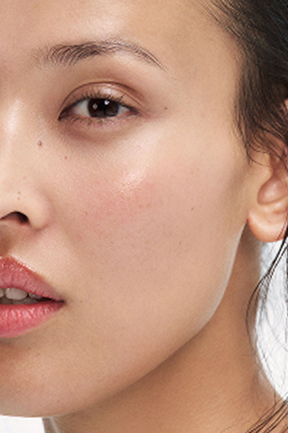 Close-up of a woman's face, showcasing her skin and expression.