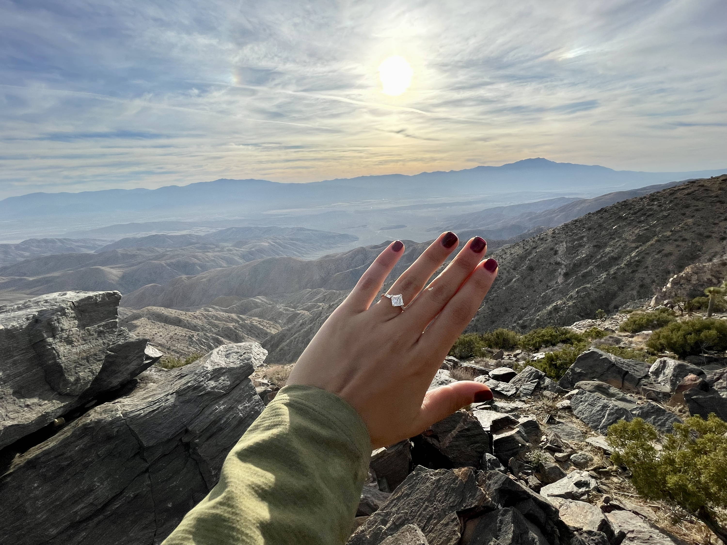engagement ring in front of mountain range
