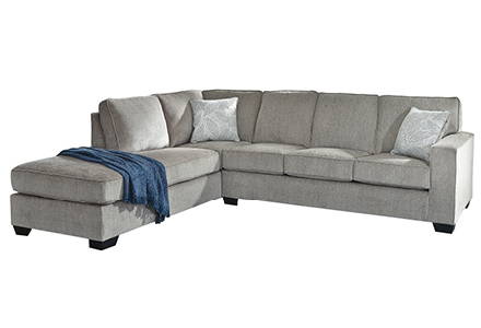 Neutral sectional sofa with blue blanket.