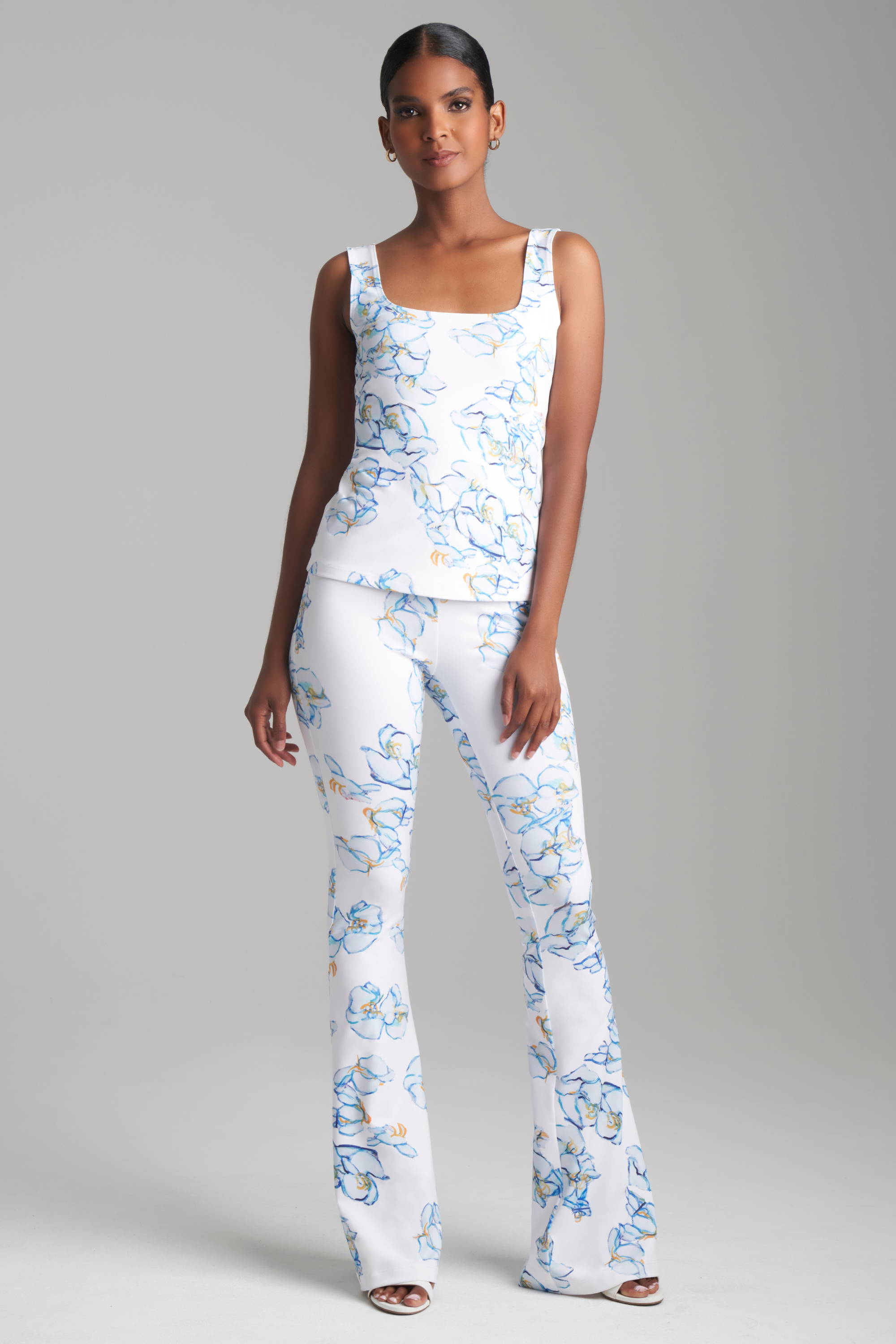 Woman wearing matching floral printed stretch knit tank top and pants by Ala von Auersperg