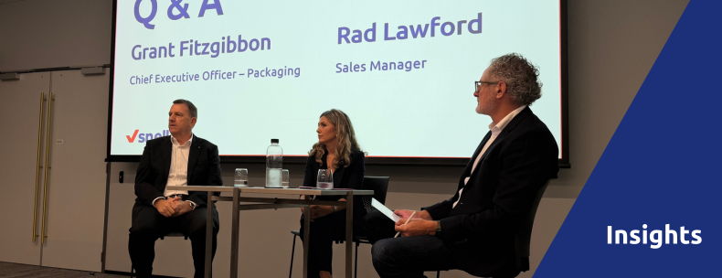 Panel discussion with three speakers on stage during a Q&A session.