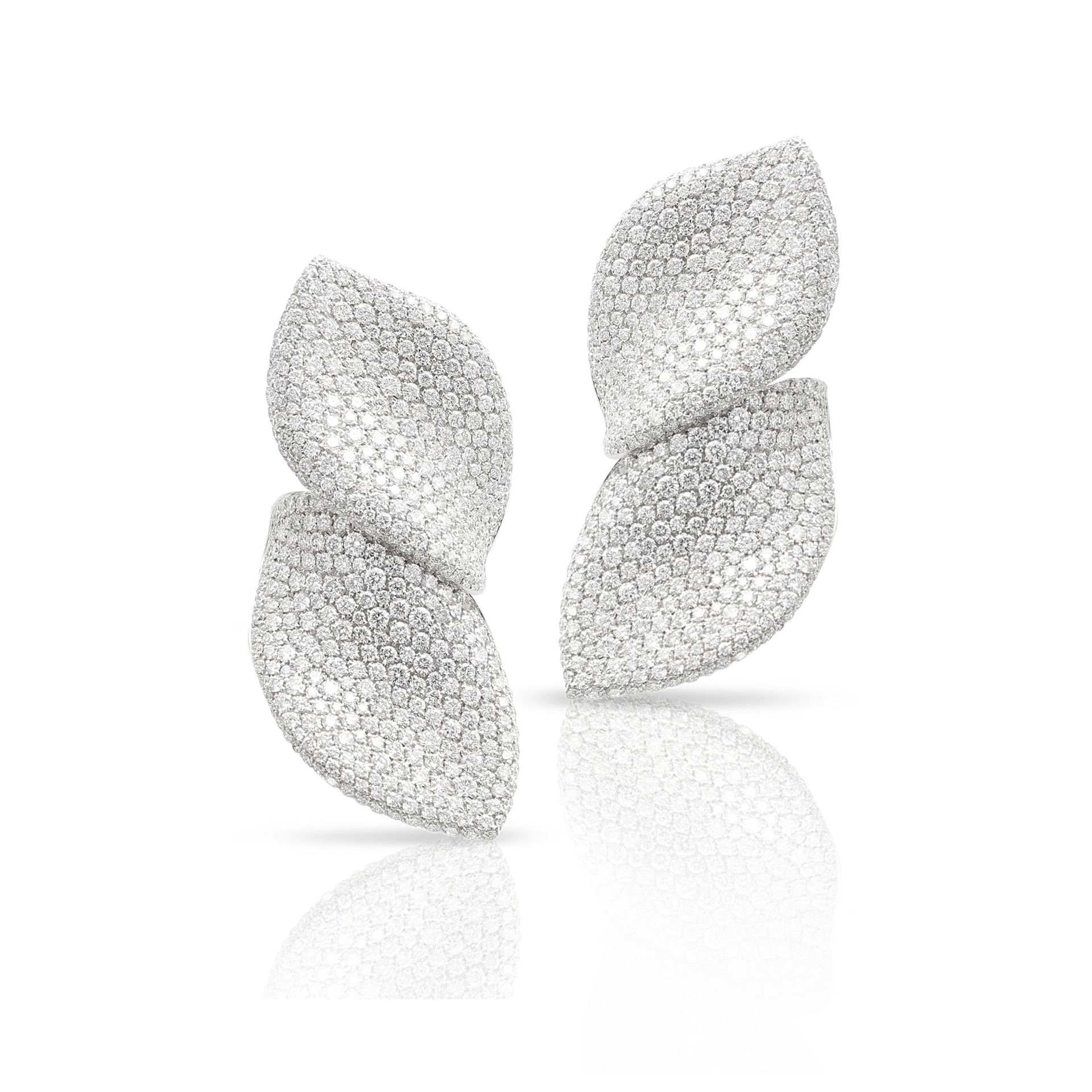 Silver leaf-shaped earrings with a textured surface, reflecting light.