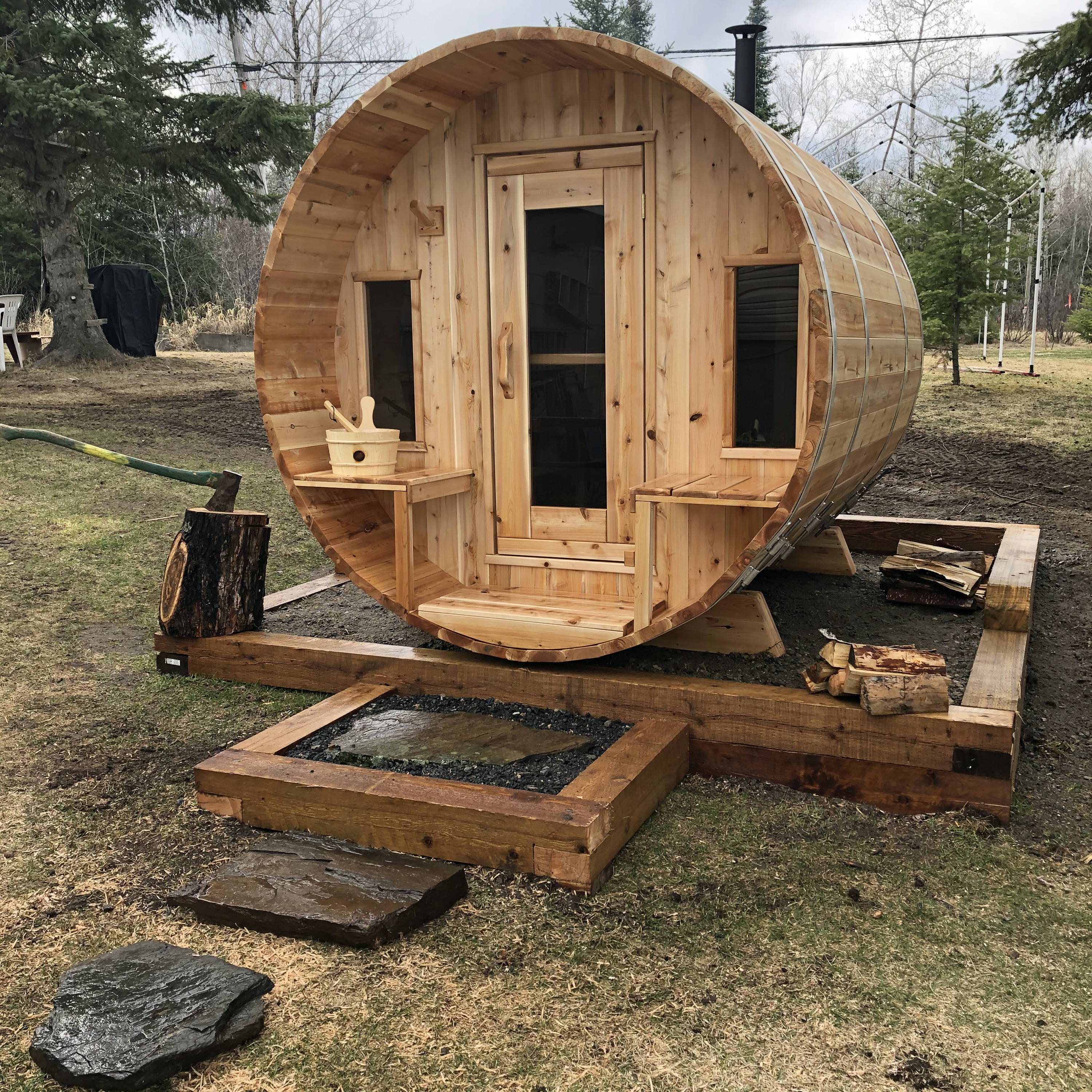 Barrel sauna sitting on gravel pad