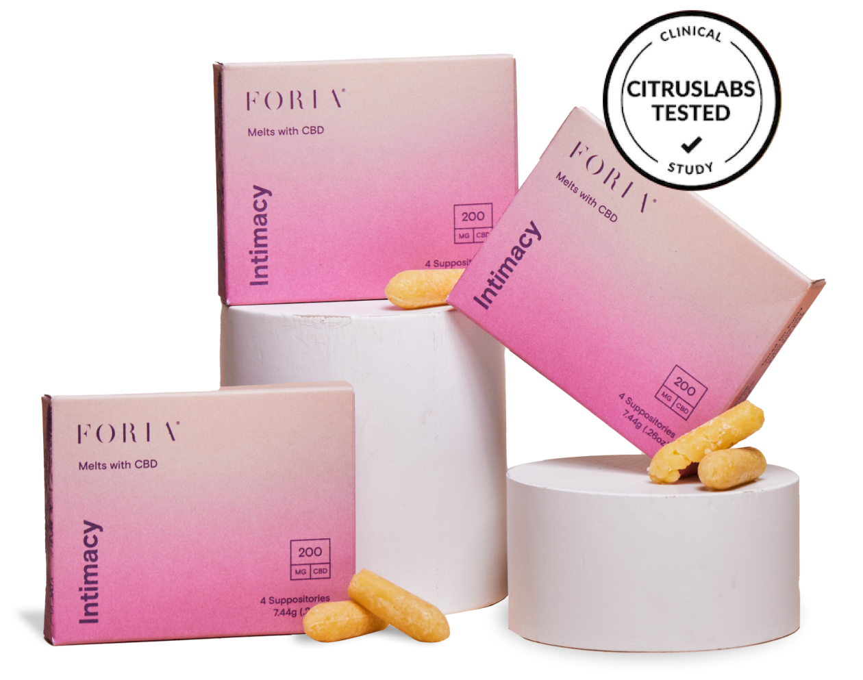 Three boxes of Foria Intimacy Melts with pink packaging design, two of them on short cylinder display pillars, and loose melts resting against one of the boxes, plus a “Citruslabs Tested Clinical Study” badge to indicate the product’s quality and efficacy.