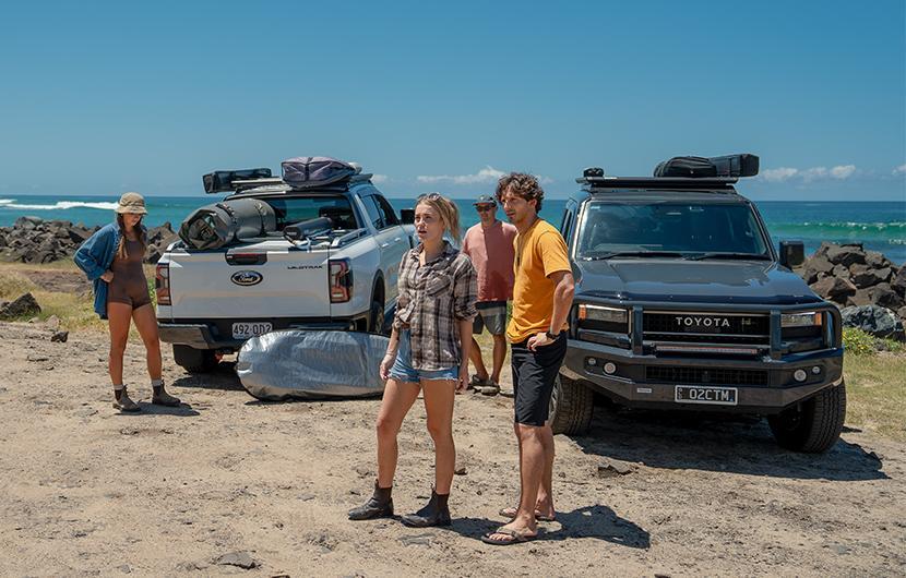 People unloading items from their vehicles