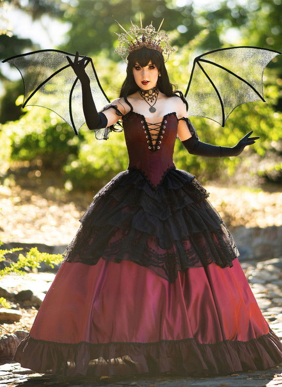A woman in a dramatic costume with wings and a crown.