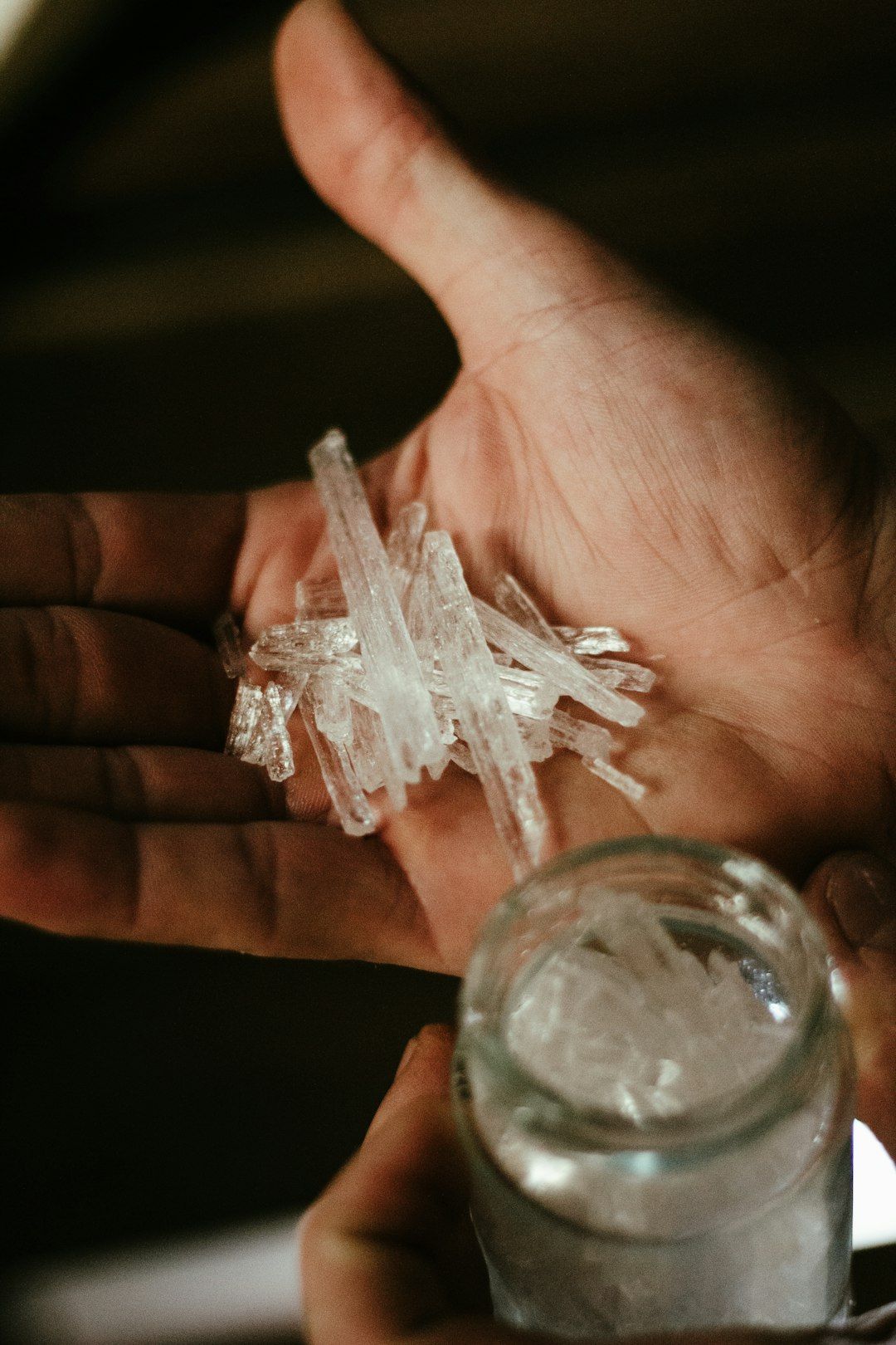 a person holding some ice in their hand