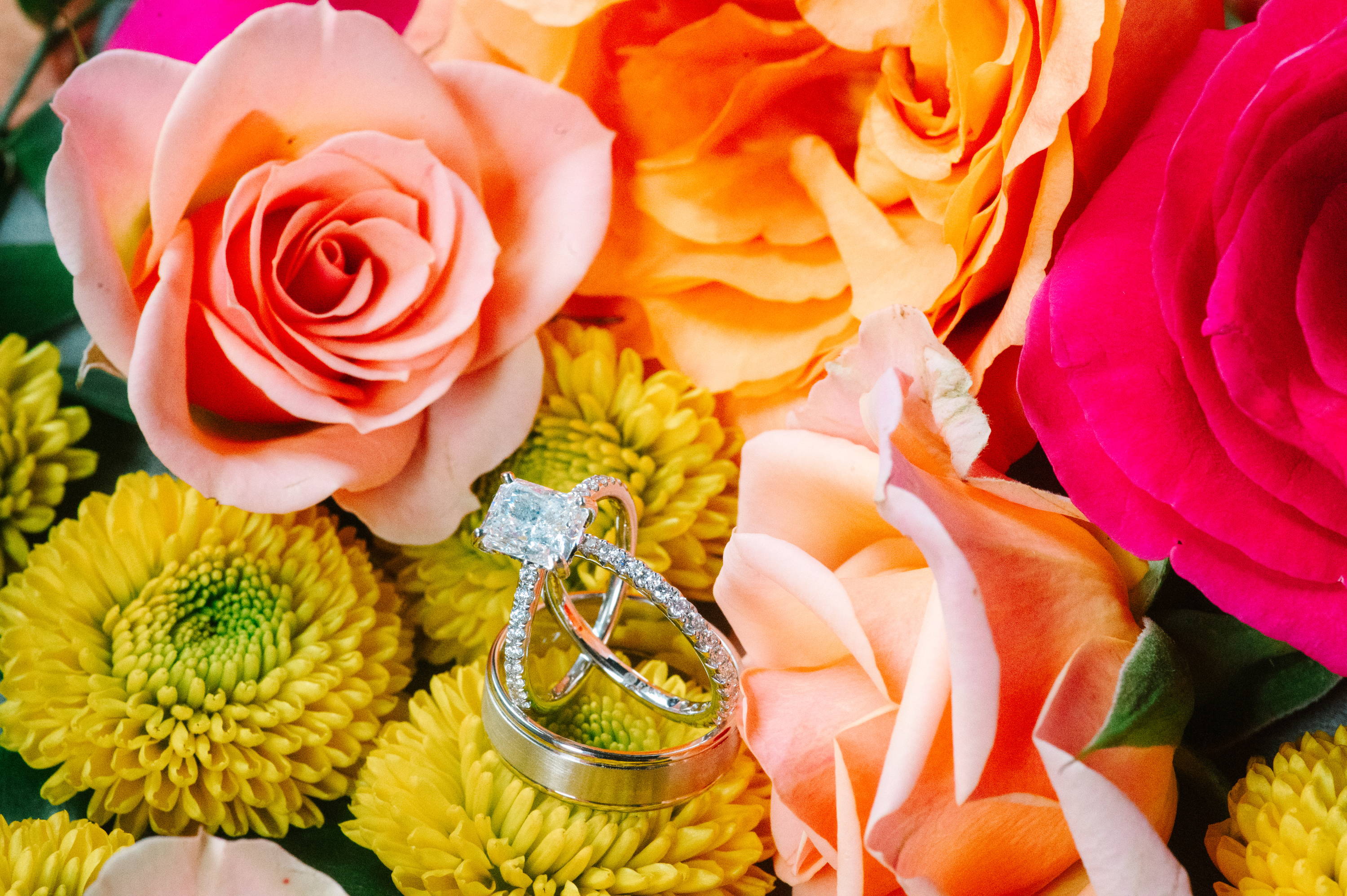 Henne engagement ring and wedding bands on flowers