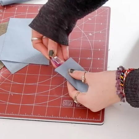 hand placing a clip on 2 pieces of fabric to hold them together before sewing