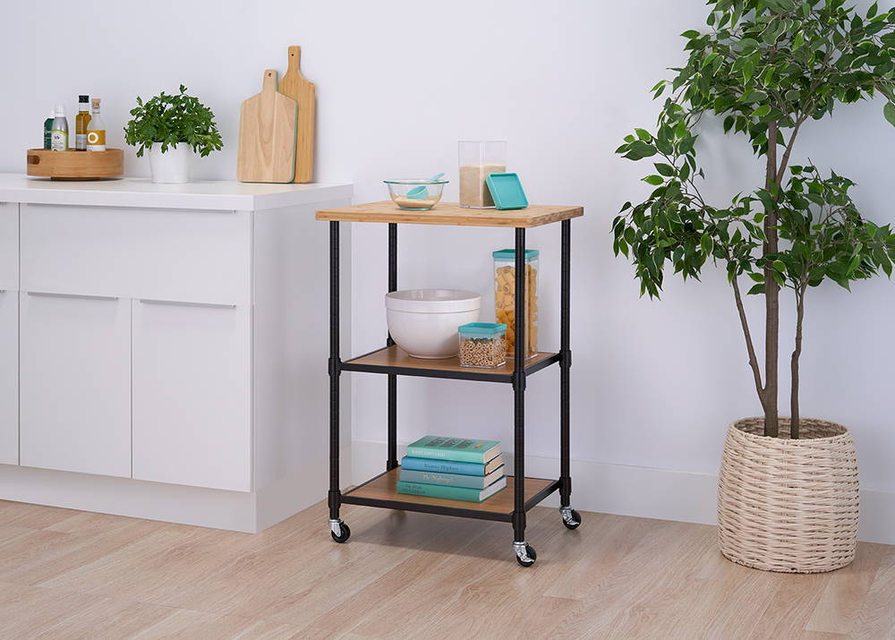3-tier kitchen cart with bamboo top in a kitchen with items on shelf