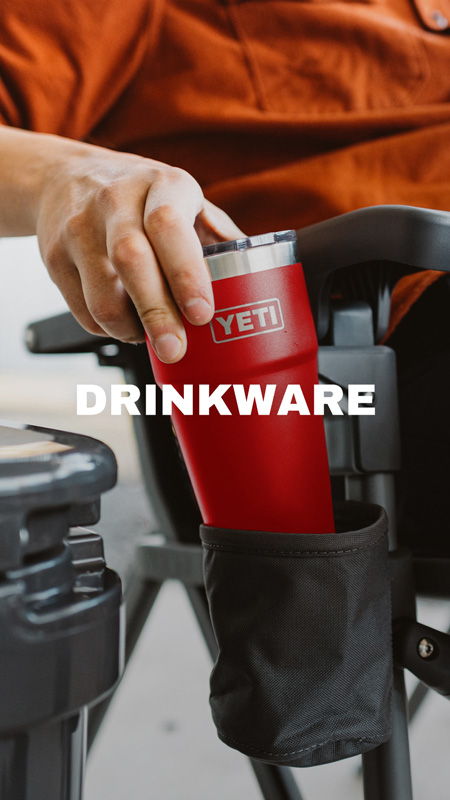 Hand placing a YETI drinkware in a chair cup holder.