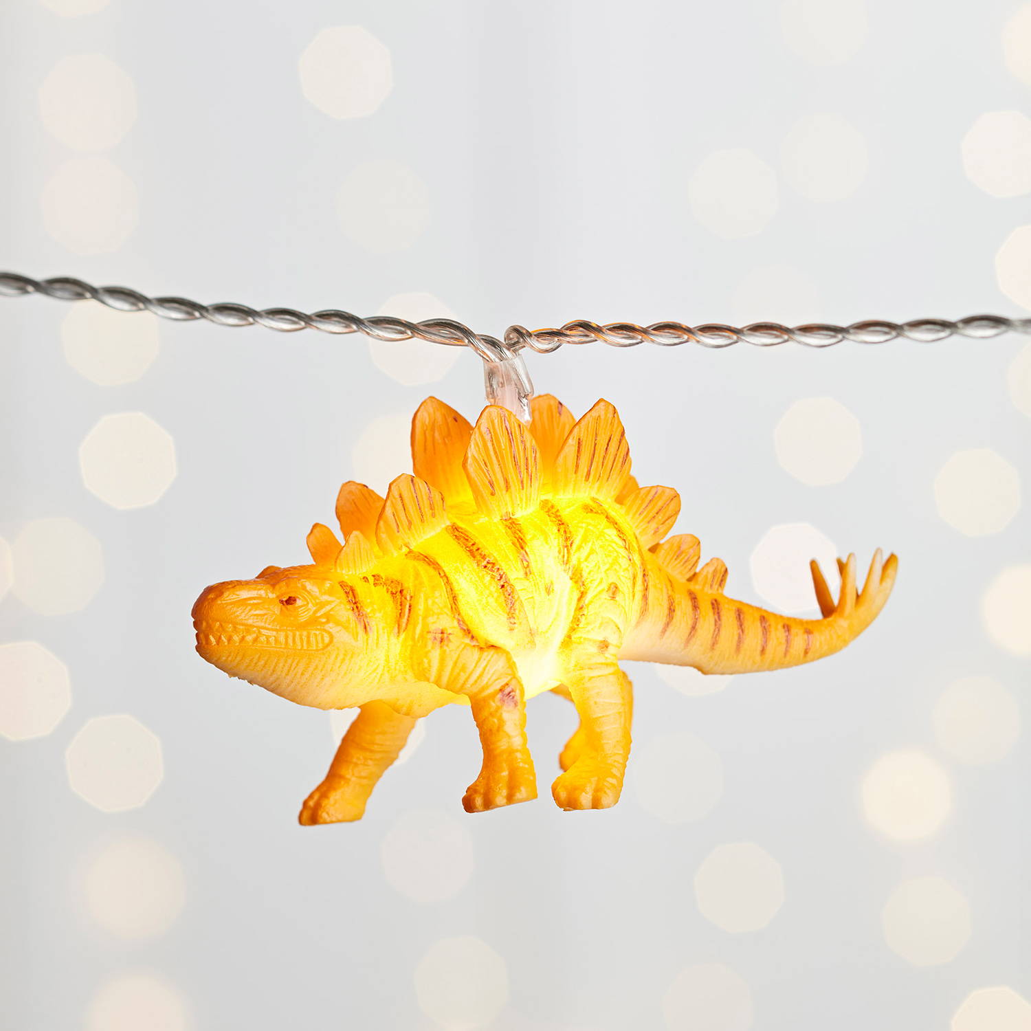 close up of multicoloured dinosaur fairy lights