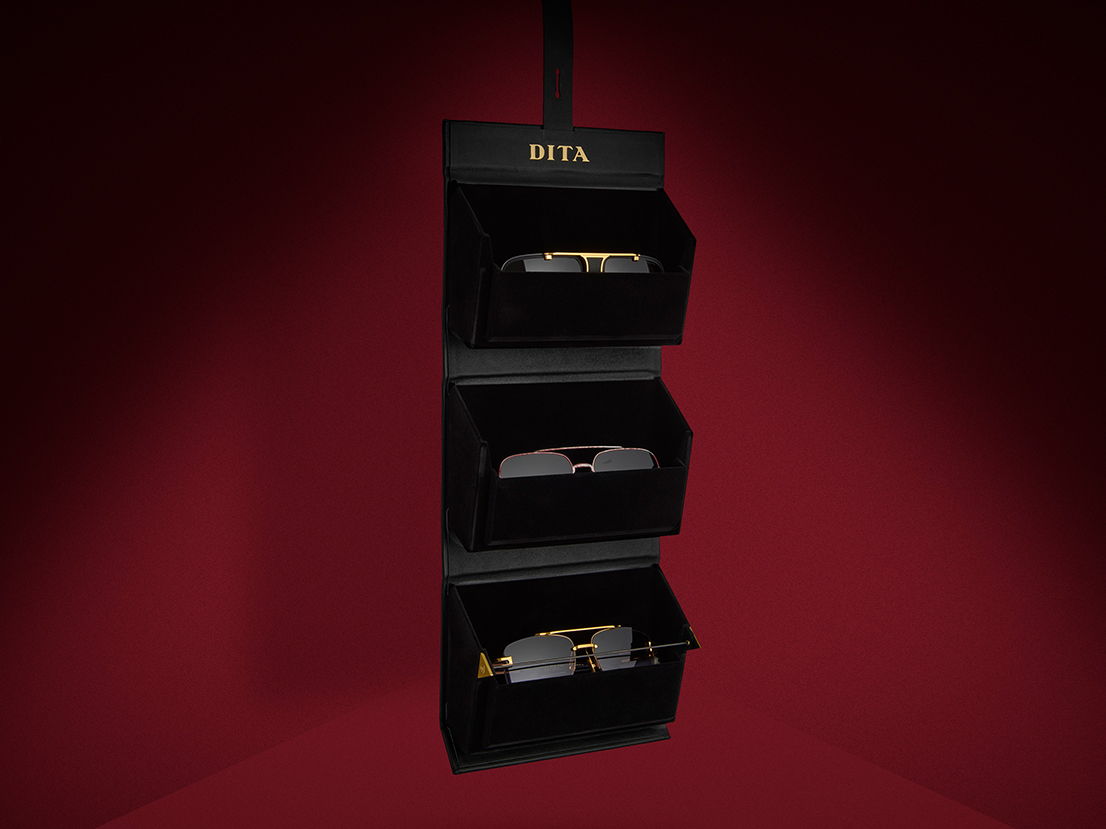 Three-tiered display stand featuring various items against a red background.