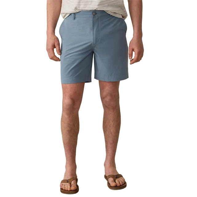 Man wearing light blue shorts and brown sandals.