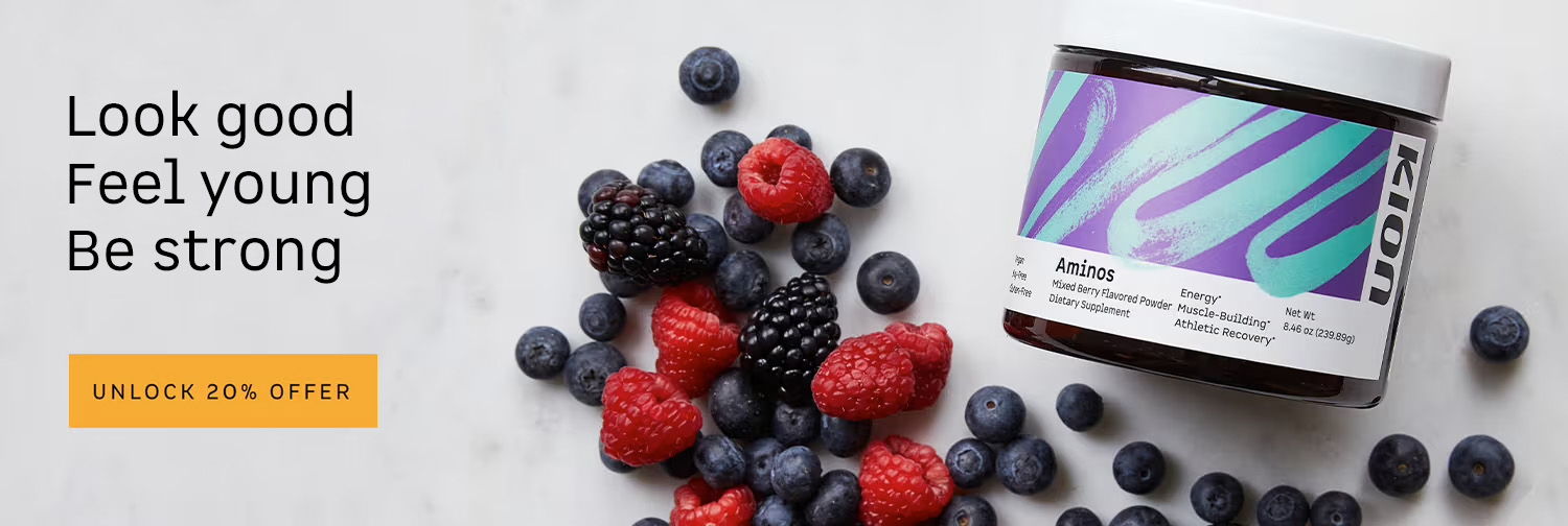 Container of supplement next to fresh berries on a light background.
