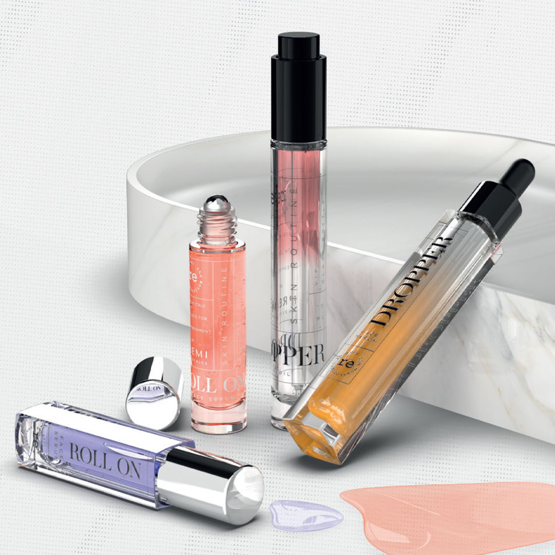 Four cosmetic lip products arranged on a marble surface.