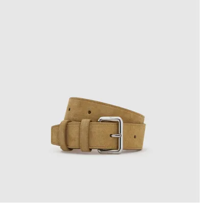 A tan suede belt with a silver buckle against a plain background.