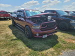 Maroon Ram 1500 with hood open on display at outdoor car show event