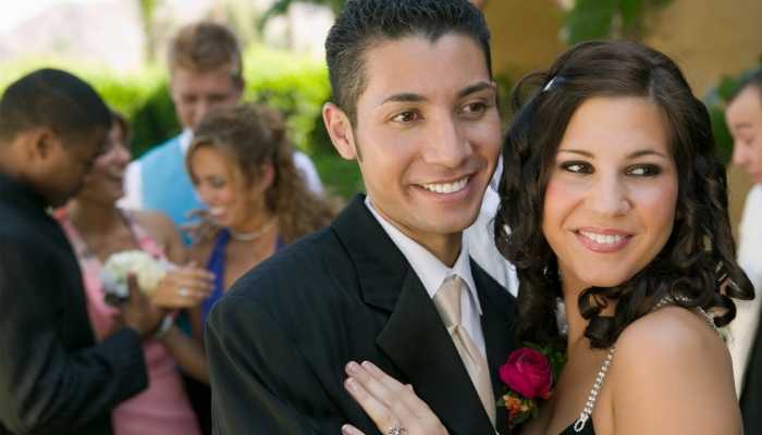 Teen couple posing at school dance