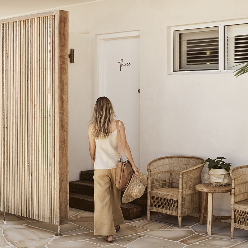 Woman walking towards a hotel room door