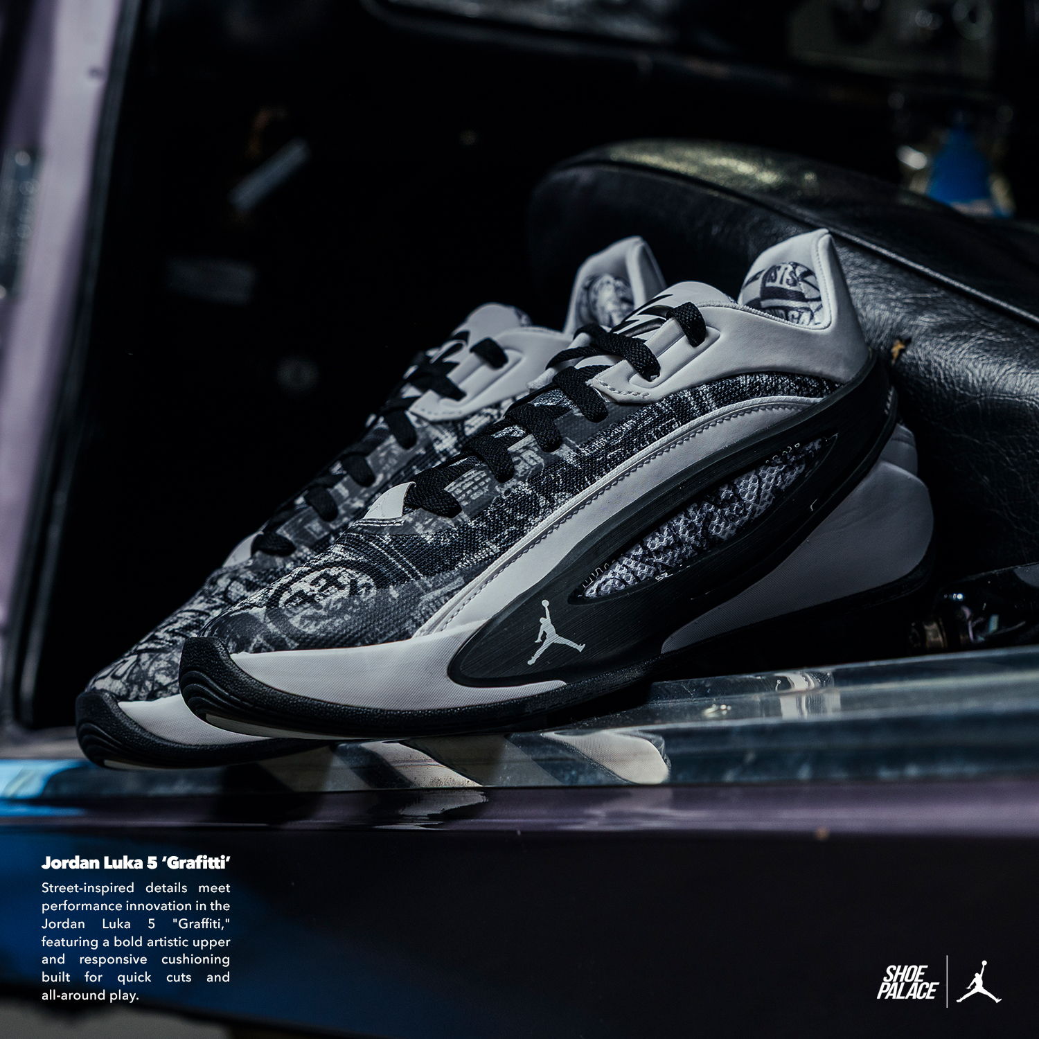 Black and gray athletic shoes displayed on a surface with text below.