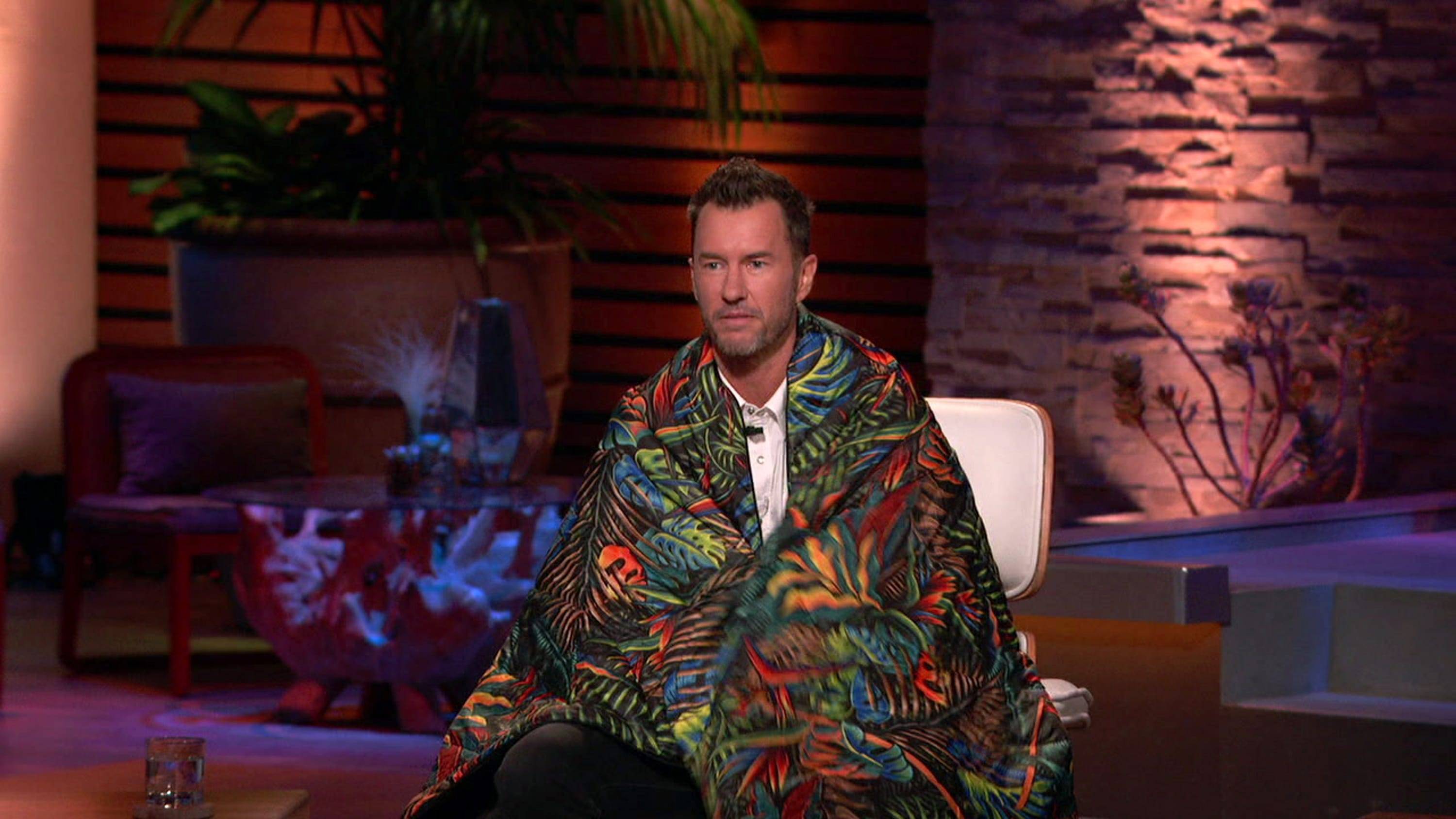 TOMS Founder and Guest Shark Blake Mycoskie tries out a Rumpl Original Puffy Blanket on Shark Tank