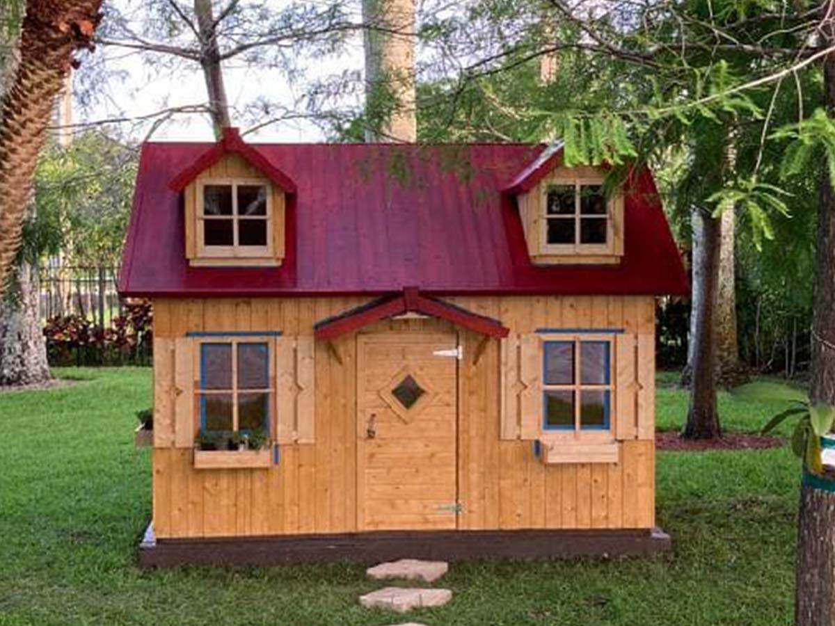 Wooden DIY Playhouse with red roof and natural color flower boxes by WholeWoodPlayhouses