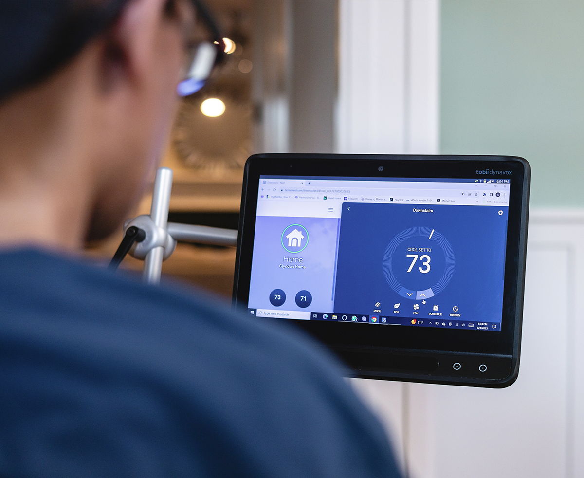 Man controlling his home environment with a Tobii Dynavox communication device