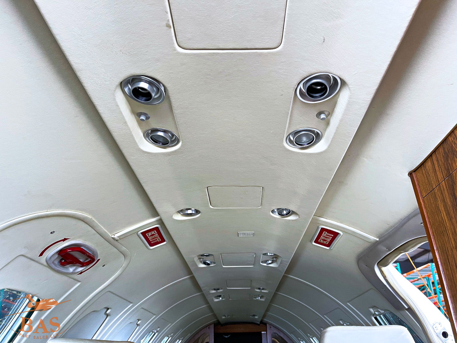 Interior ceiling of an aircraft, featuring lights and air vents.
