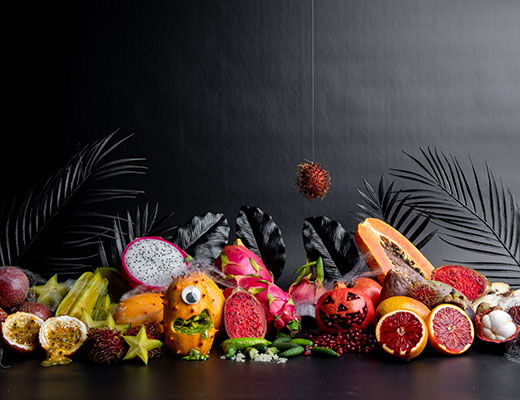 Colorful assortment of exotic fruits on a dark background.