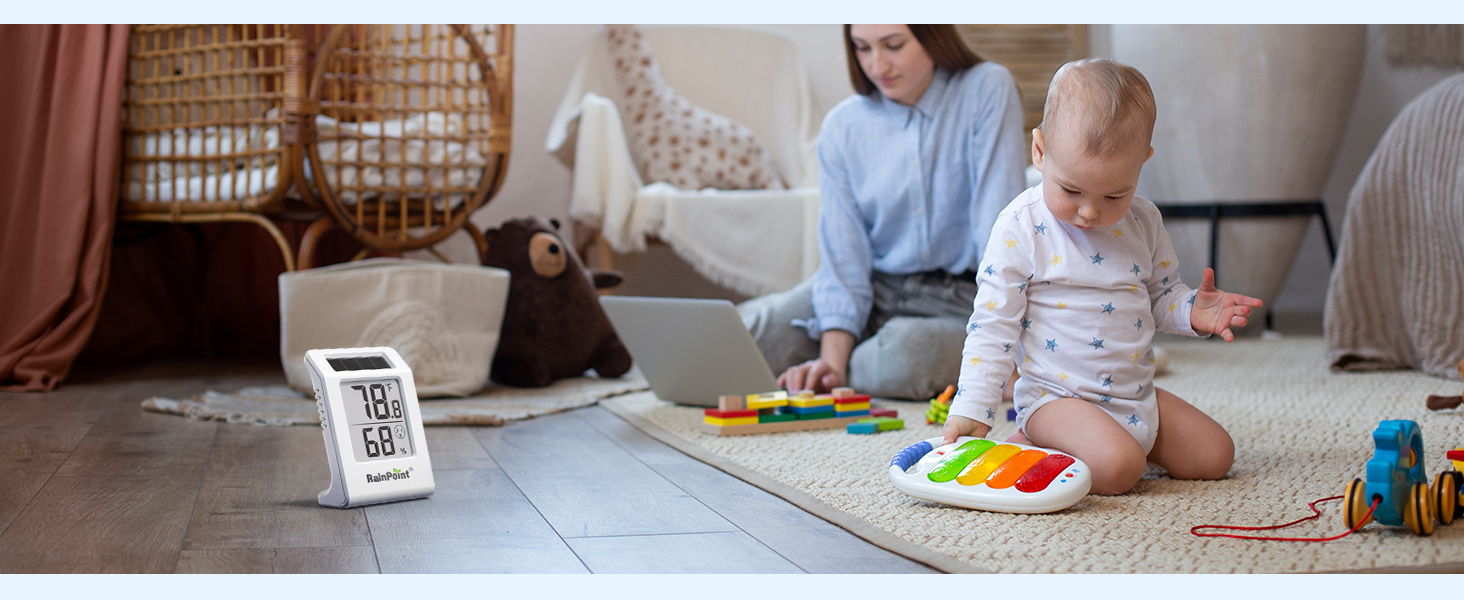 A child playing with a colorful toy while an adult works nearby.