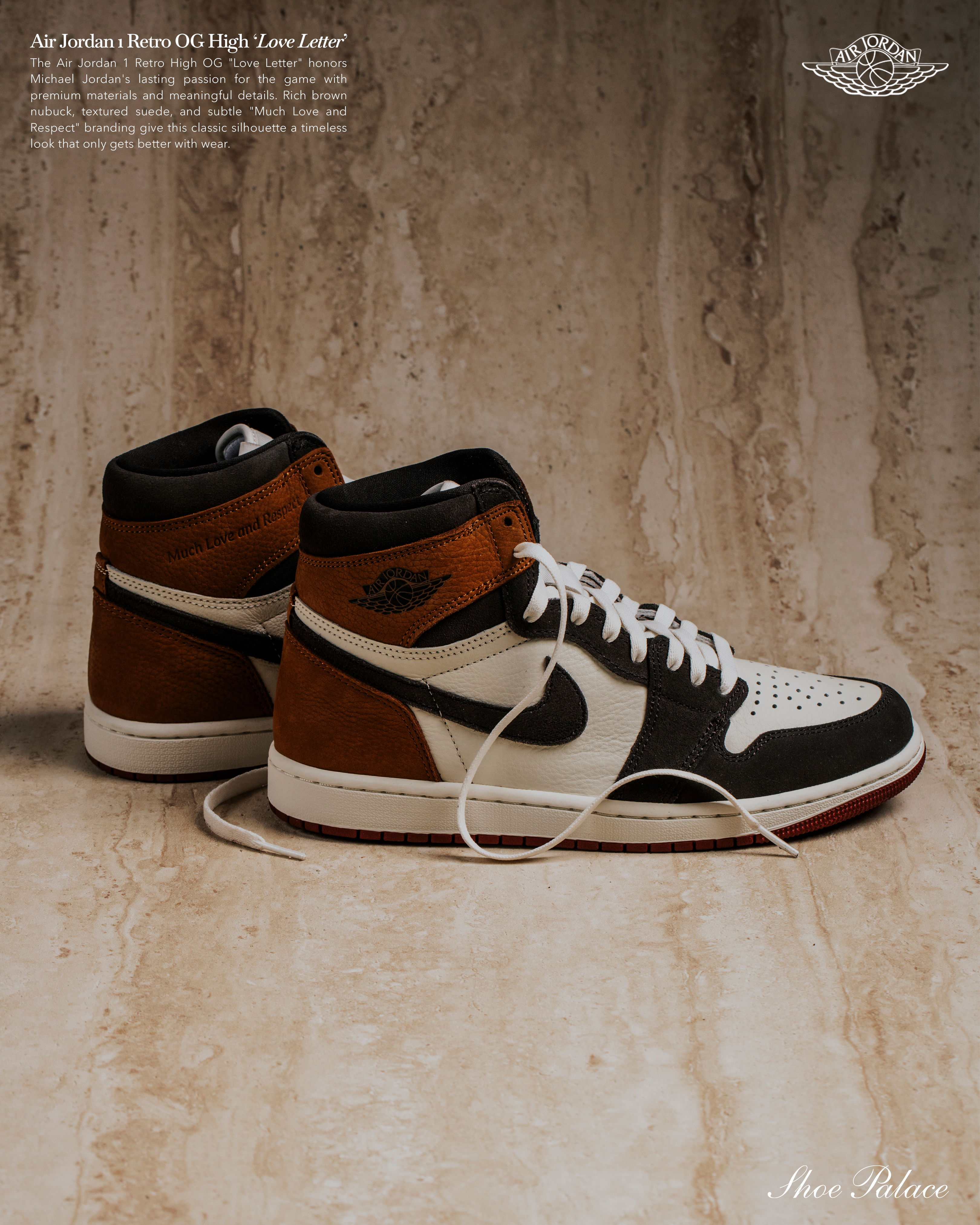 A pair of stylish high-top sneakers on a textured surface.